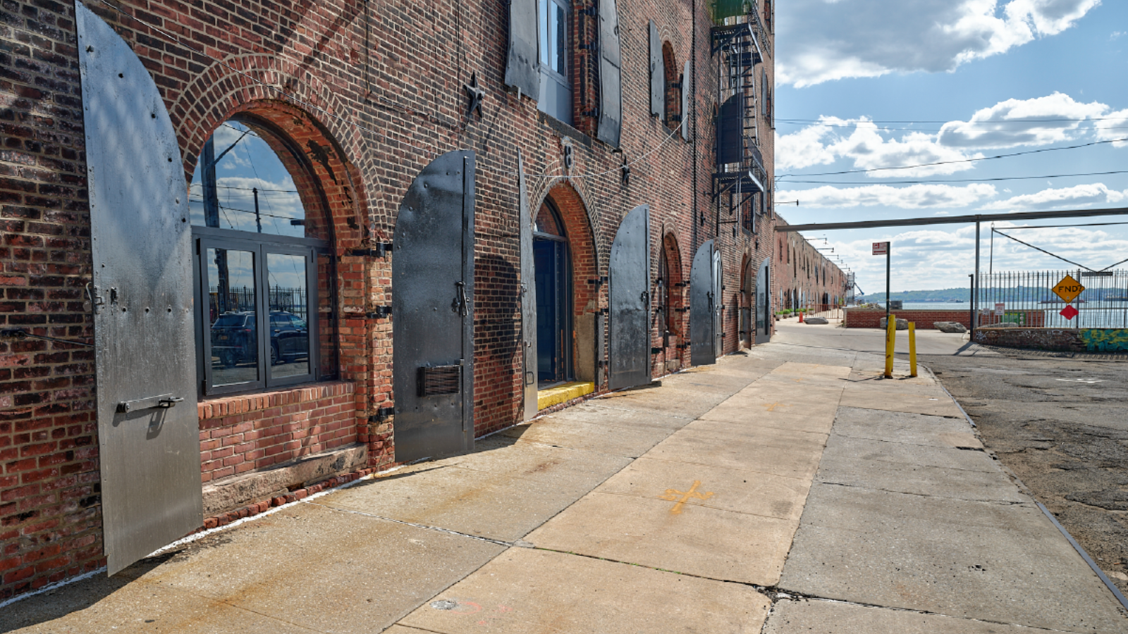Photo of the Red Hook waterfront artist warehouse buildings.