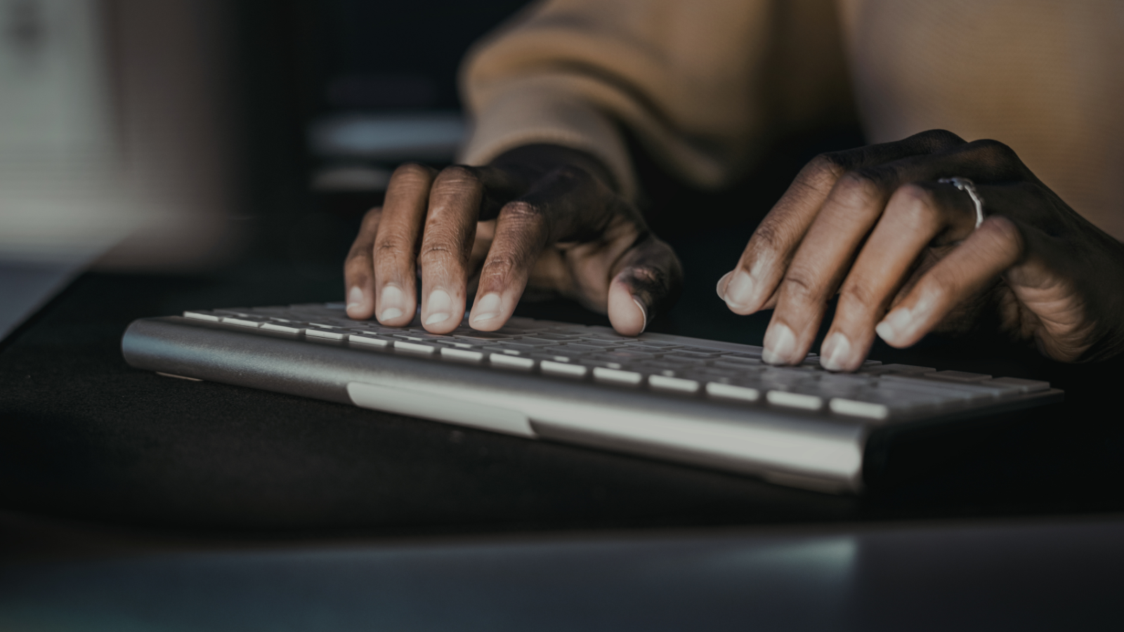 Photo of someone typing on a keyboard.